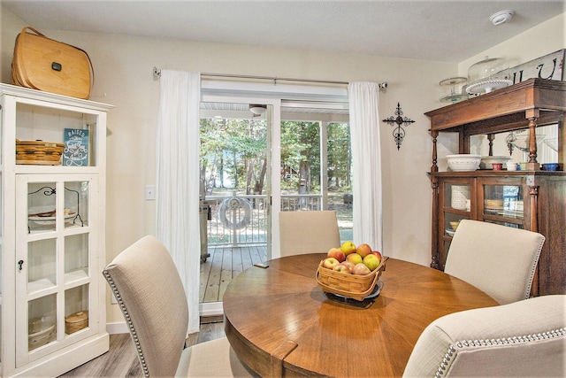 dining space with hardwood / wood-style floors