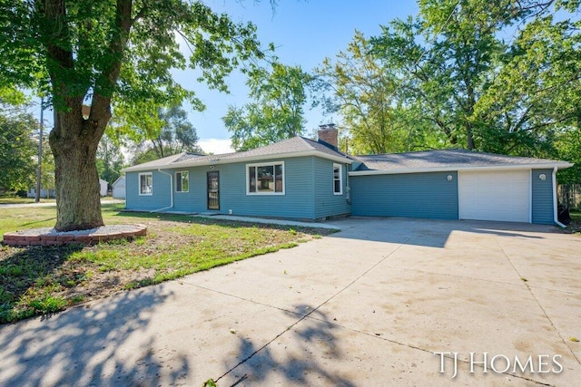 single story home featuring a front yard and a garage