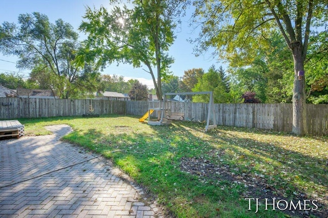 view of yard featuring a playground and a patio area