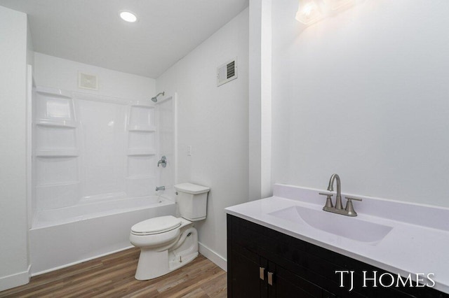 full bathroom with vanity, hardwood / wood-style flooring, toilet, and shower / washtub combination