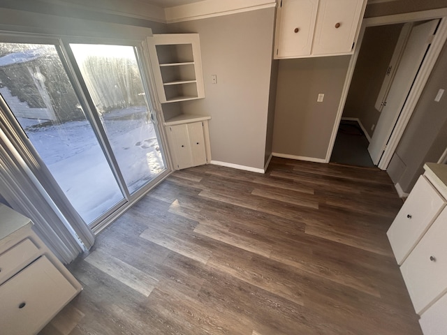 kitchen featuring dark wood-type flooring and white cabinetry