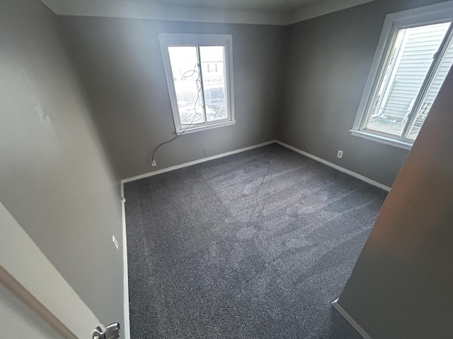 carpeted spare room with a healthy amount of sunlight