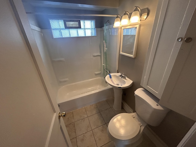 bathroom featuring shower / bathing tub combination, tile patterned floors, and toilet