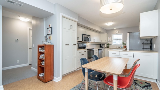 kitchen with white cabinetry and stainless steel appliances