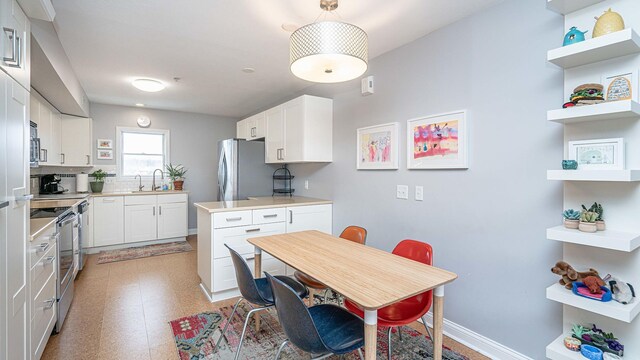 kitchen featuring white cabinets, sink, and stainless steel appliances