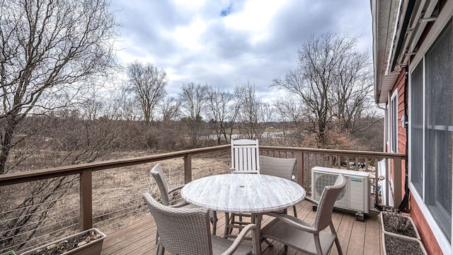 wooden deck featuring ac unit