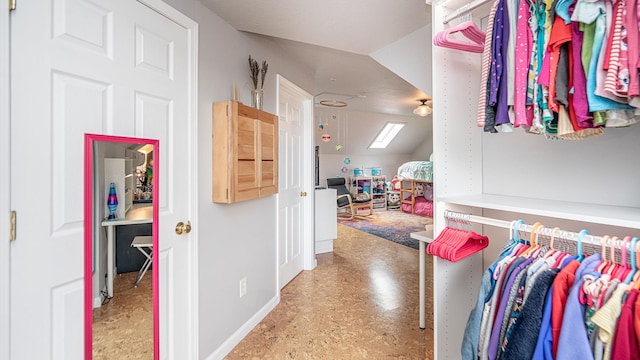 walk in closet with vaulted ceiling