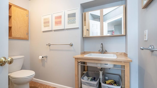 bathroom featuring toilet and sink