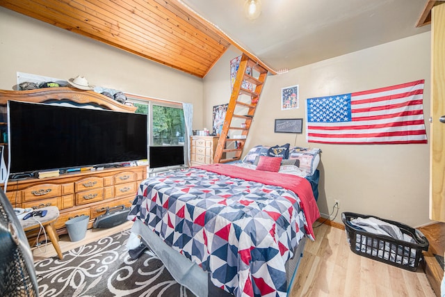 bedroom featuring lofted ceiling, wooden ceiling, and wood-type flooring