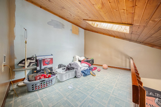 interior space featuring lofted ceiling with skylight and wooden ceiling