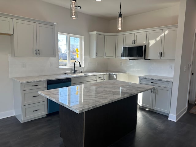 kitchen featuring white cabinetry, a center island, sink, light stone counters, and pendant lighting