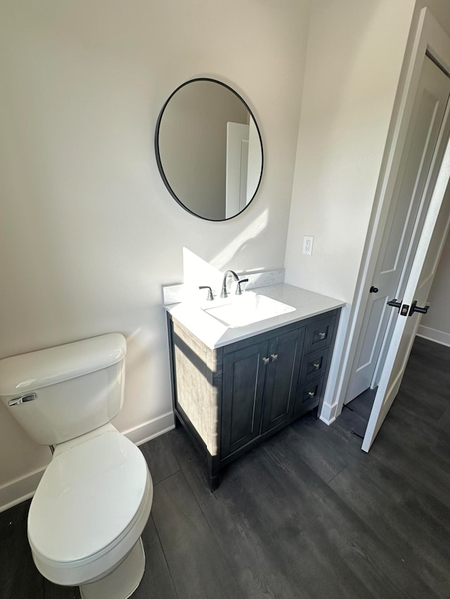 bathroom featuring vanity, toilet, and wood-type flooring