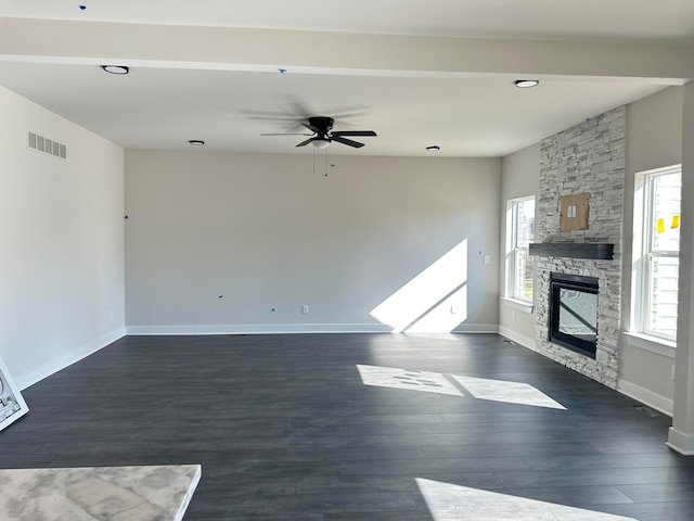 unfurnished living room featuring dark hardwood / wood-style floors, ceiling fan, and a fireplace