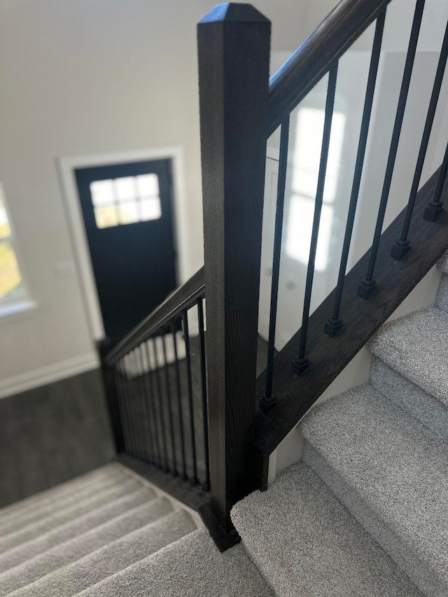 staircase featuring carpet flooring and plenty of natural light