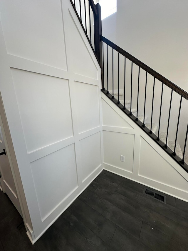 stairs featuring wood-type flooring