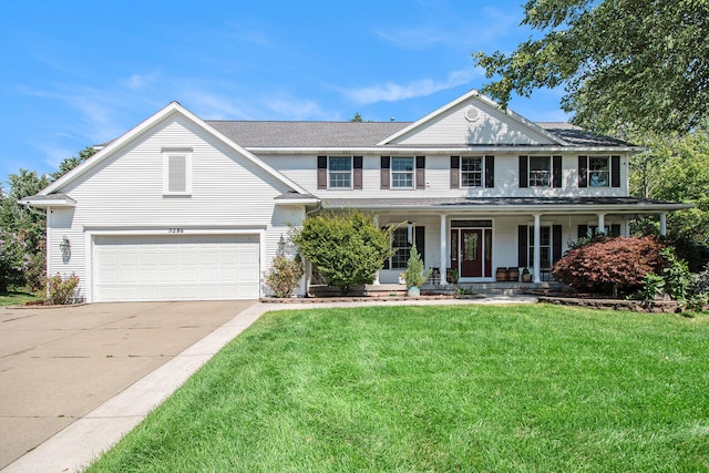 view of front of home featuring a porch, a garage, and a front yard