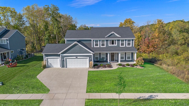 view of front of house with a porch, a garage, and a front yard