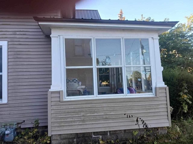 view of home's exterior with a sunroom