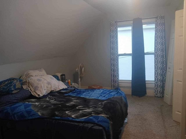 carpeted bedroom featuring vaulted ceiling