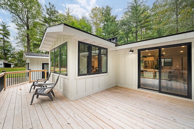 wooden terrace featuring a sunroom