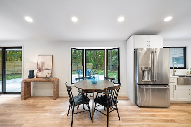 dining room featuring light hardwood / wood-style floors and sink