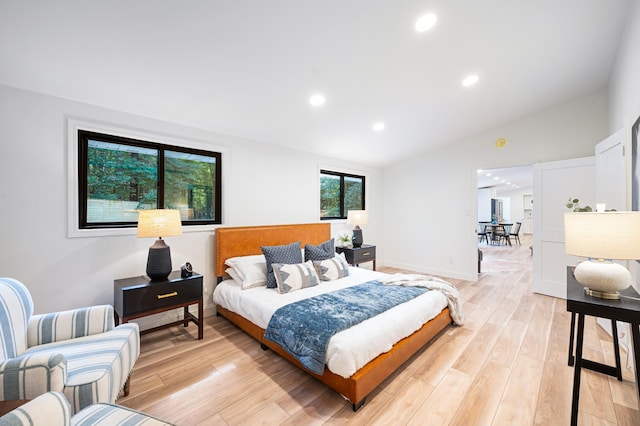 bedroom featuring lofted ceiling and light hardwood / wood-style floors