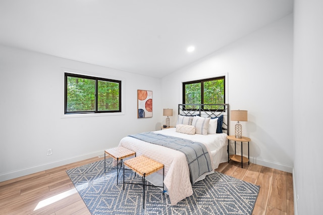 bedroom featuring light hardwood / wood-style flooring and vaulted ceiling