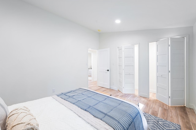 bedroom featuring vaulted ceiling and hardwood / wood-style flooring