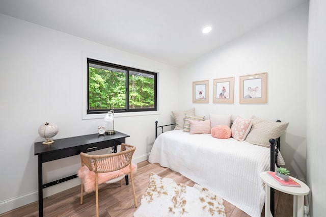 bedroom with lofted ceiling and hardwood / wood-style floors