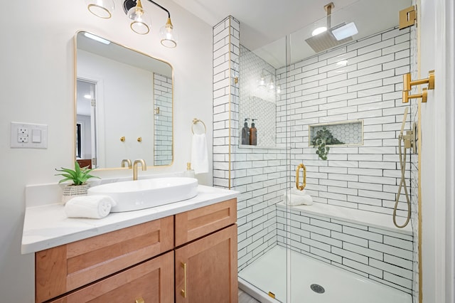 bathroom with walk in shower and vanity