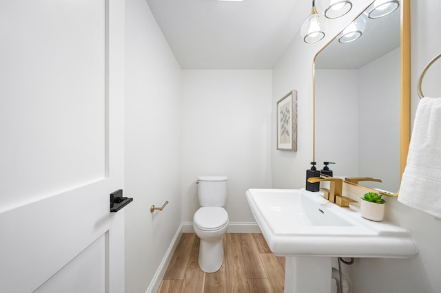 bathroom featuring toilet and hardwood / wood-style flooring