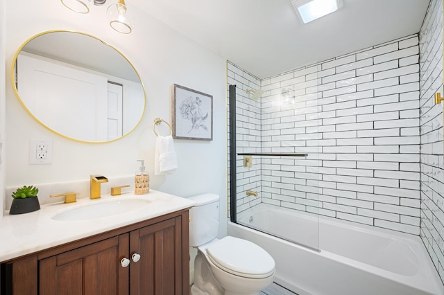 full bathroom with tiled shower / bath, vanity, and toilet