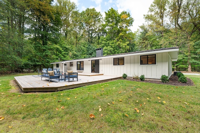 back of house featuring a deck and a yard