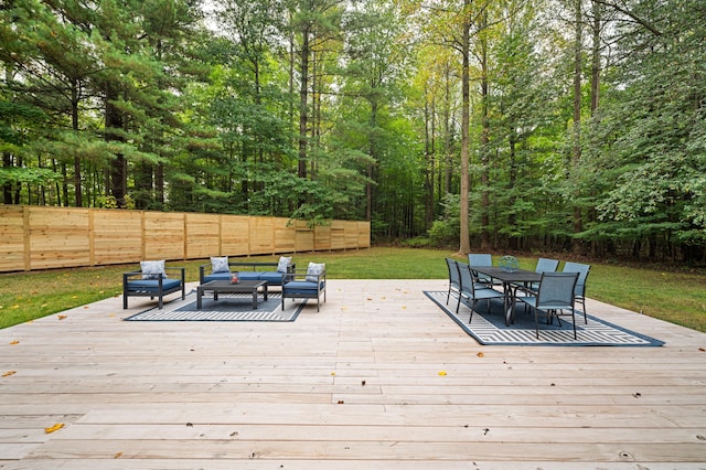 wooden terrace featuring a lawn and outdoor lounge area