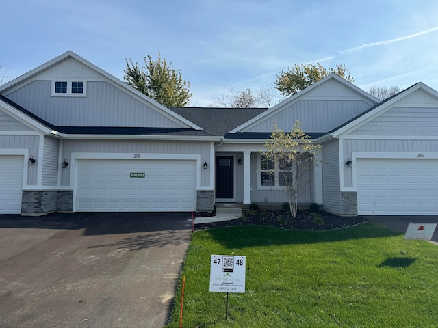 view of front facade with a garage and a front lawn