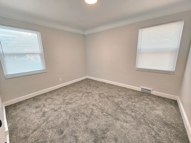 unfurnished room with crown molding and carpet flooring