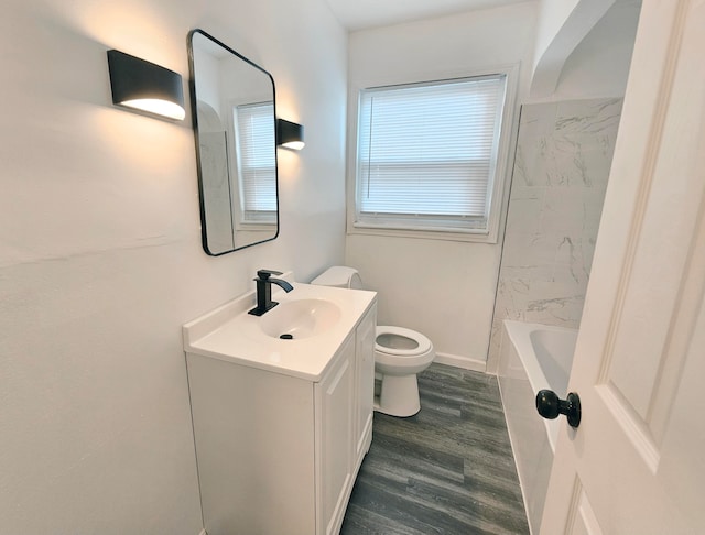 bathroom featuring hardwood / wood-style flooring, toilet, and vanity