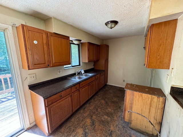 kitchen featuring a textured ceiling and sink