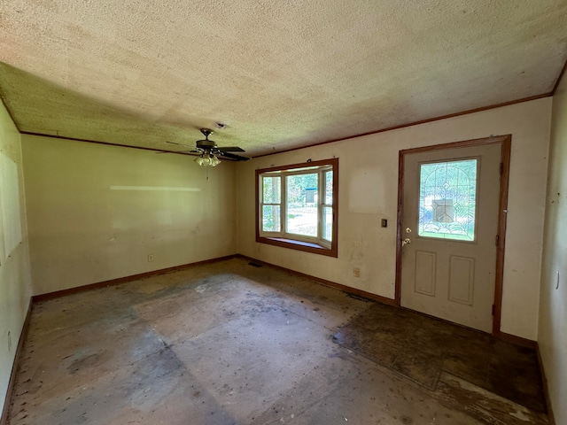 foyer entrance with ceiling fan, a healthy amount of sunlight, and a textured ceiling