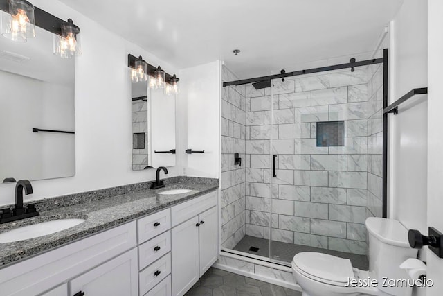 bathroom with vanity, toilet, an enclosed shower, and tile patterned floors