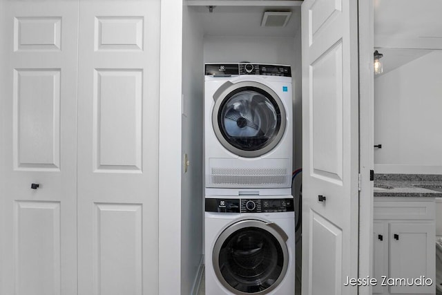 laundry room with stacked washer and dryer