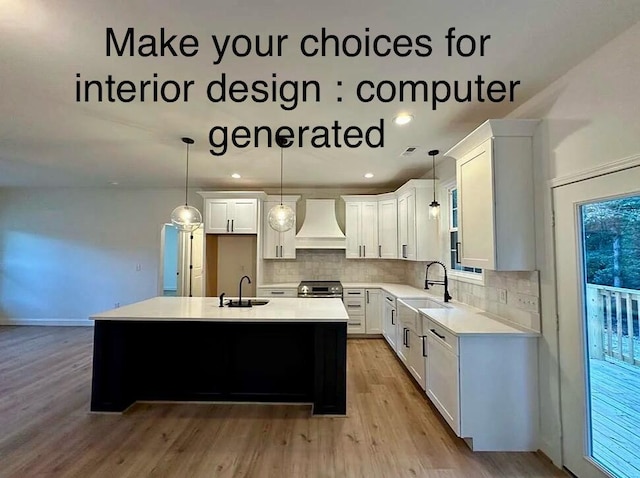 kitchen featuring hanging light fixtures, sink, a kitchen island, white cabinetry, and custom range hood