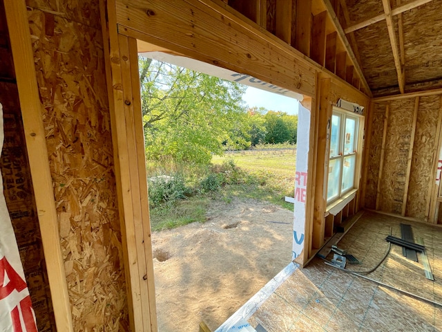 entryway featuring a wealth of natural light and vaulted ceiling