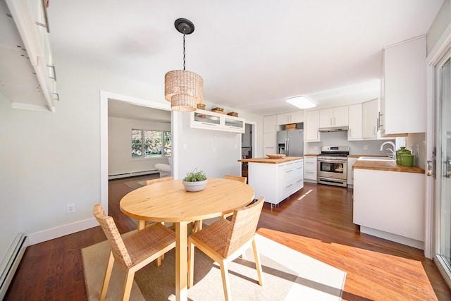 dining area featuring baseboard heating, sink, dark hardwood / wood-style floors, and a notable chandelier