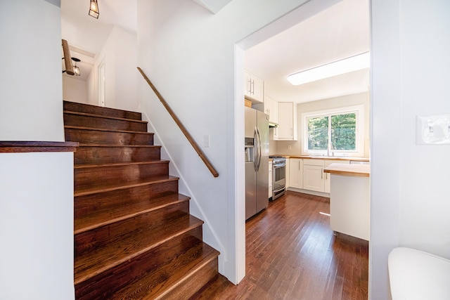 staircase featuring wood-type flooring