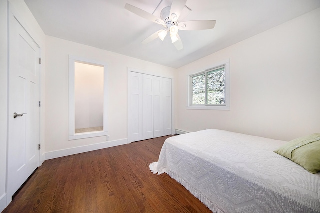 bedroom featuring ceiling fan, dark wood-type flooring, a baseboard radiator, and a closet