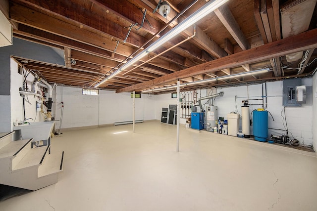 basement with gas water heater, baseboard heating, sink, and electric panel