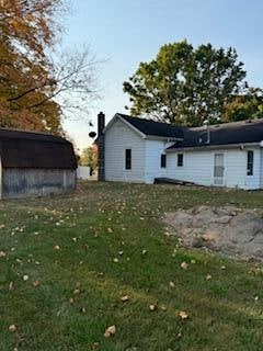 back of house featuring a yard