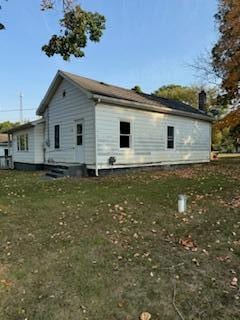 rear view of property featuring a yard