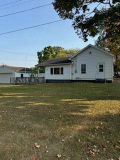 back of house with a lawn